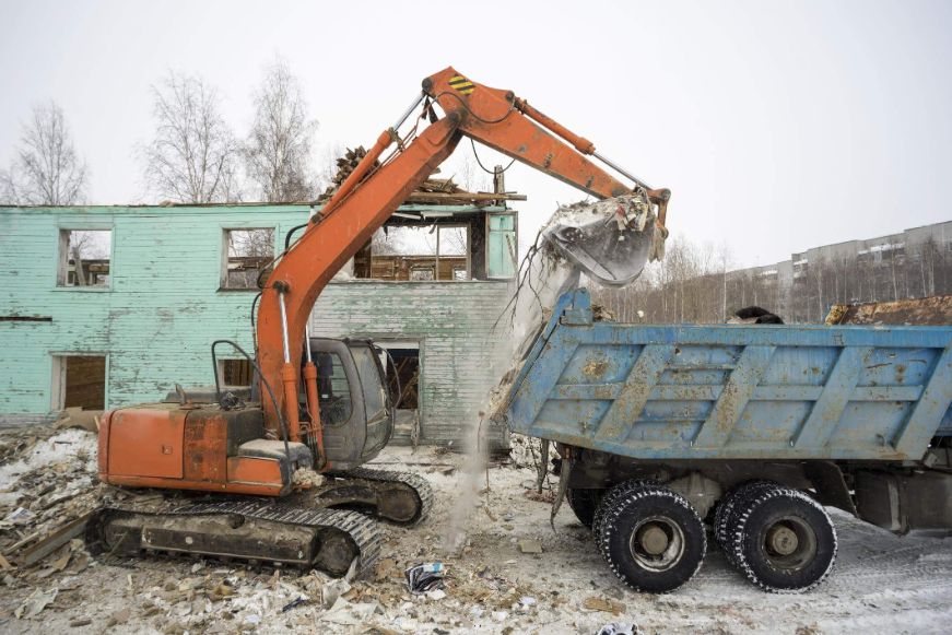 Commercial-Demolition-Service Excavator loading up a truck with commercial demolition waste