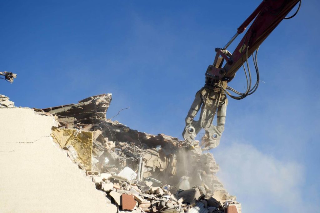 GRND-Demolition-and-Excavation-Toronto-Services Giant cutting machine chopping up a demolishing a building before excavating can start