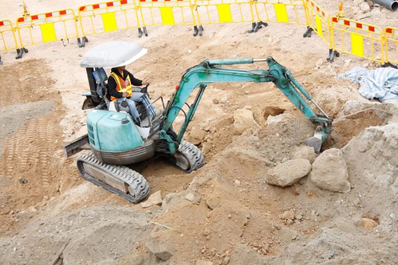 Excavator levelling terrain for residential purposes