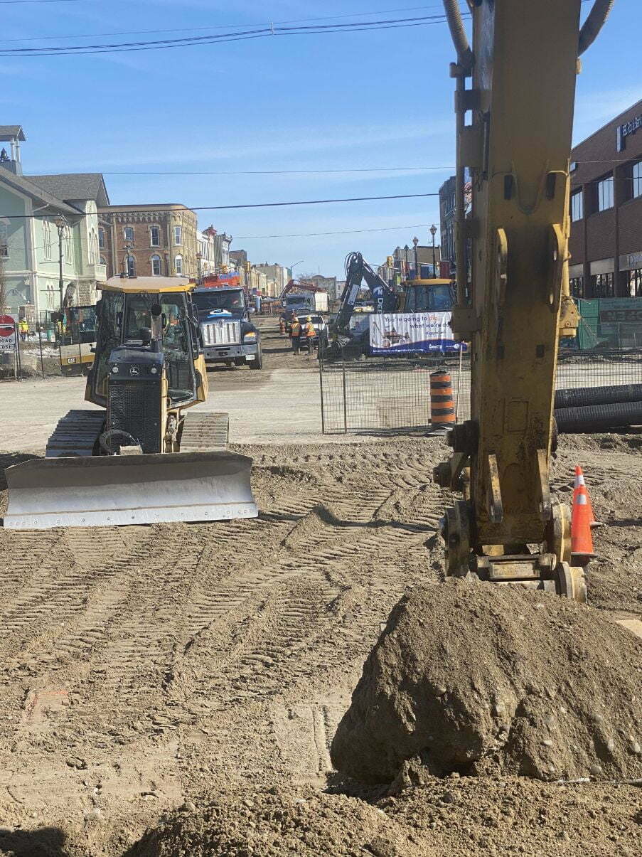 Excavation Services Toronto An excavator and bulldozer moving soil on an urban commercial plot of land