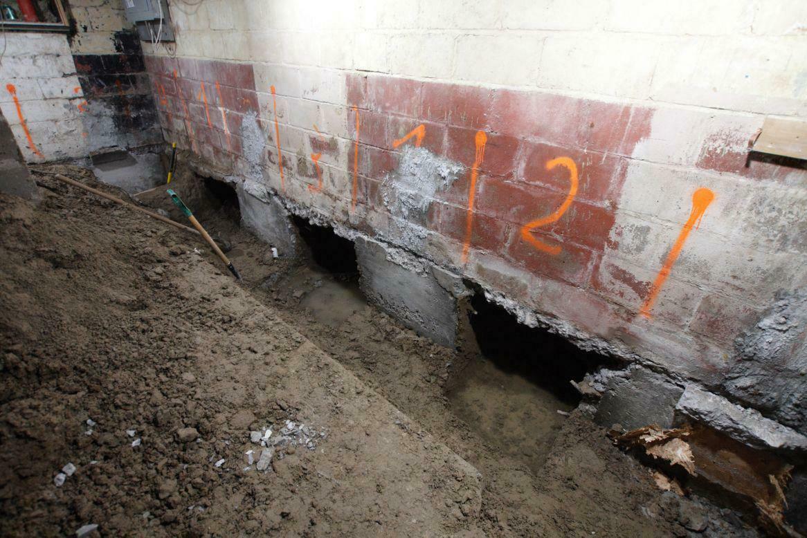 Underpinning Toronto A basement with dug out trenches and numbers written on the wall in preparation for underpinning in Toronto, ON