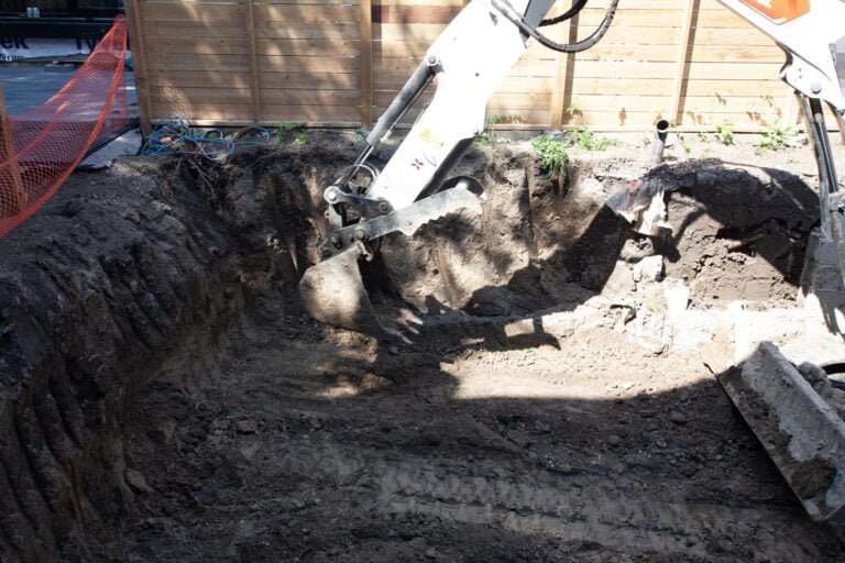 grading the ground with an excavator