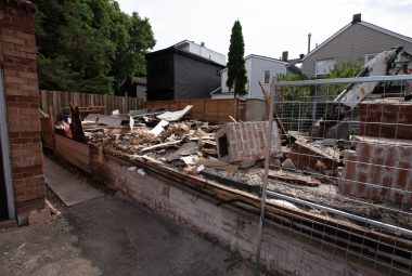 demolition waste ready to be transported with an excavator and bins